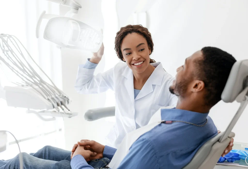 female dentist turning on lamp before treatment Smiles On Jane Family Dentistry